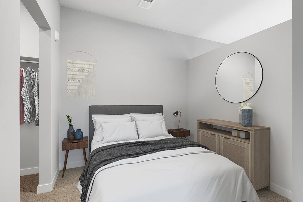 Alcove style bedroom with partial wall and walk in closet
